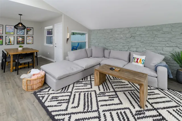 a living room with furniture and a rug