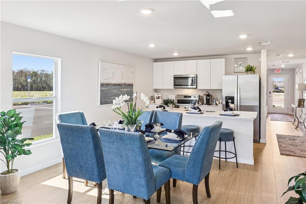 8040 Cedar Ky Way Lehigh Acres, FL 33971 - Photo 11 of 27 Model home. Dining space with light wood-style floors and recessed lighting