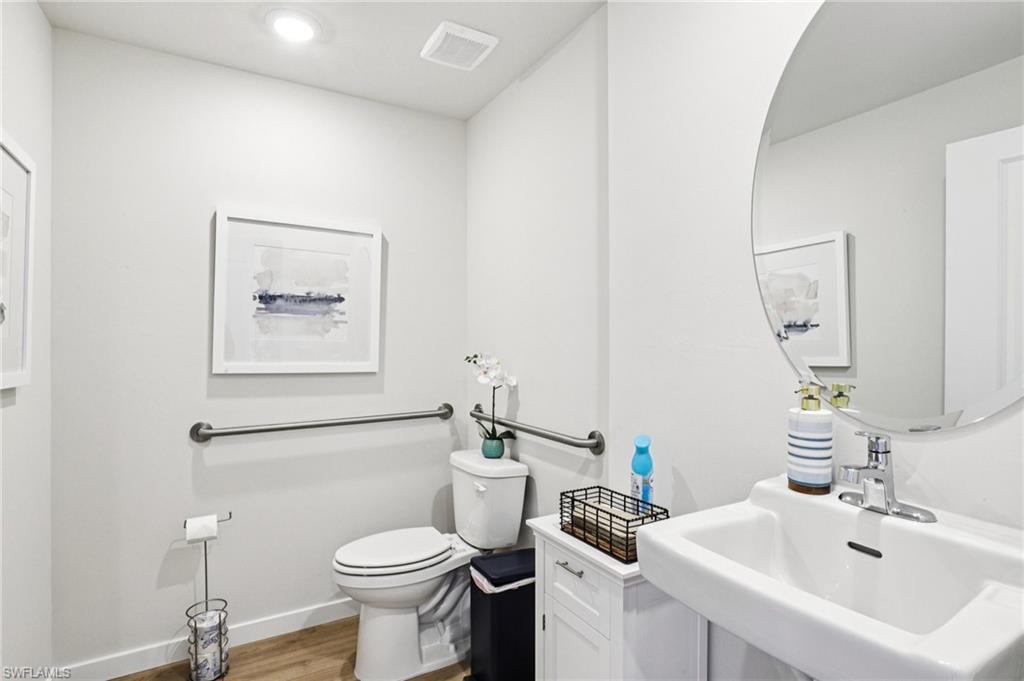 8040 Cedar Ky Way Lehigh Acres, FL 33971 - Photo 17 of 27 Model home. Half bath featuring toilet and light wood-style flooring