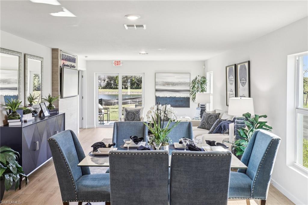 8040 Cedar Ky Way Lehigh Acres, FL 33971 - Photo 9 of 27 Model home. Dining room with light wood-style floors and baseboards