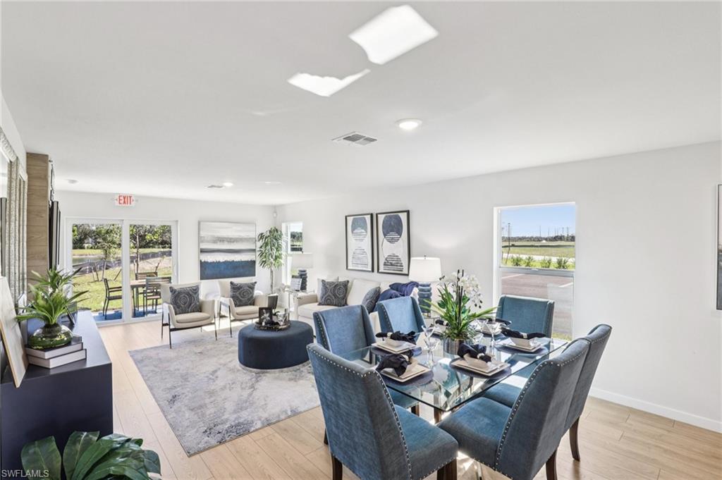 8040 Cedar Ky Way Lehigh Acres, FL 33971 - Photo 10 of 27 Model home. Dining space with light wood finished floors and plenty of natural light