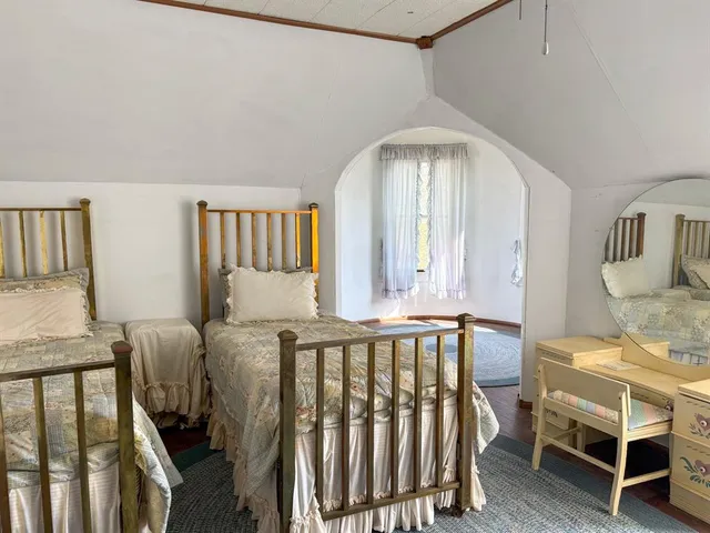 a bedroom with furniture and wooden floor