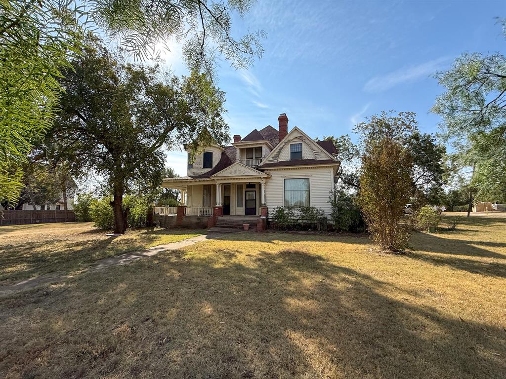641 West 2nd Street Baird, TX 79504 - Photo 2 of 15 a front view of a house with a yard and garage