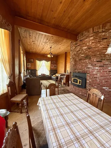 a large bedroom with a bed and wooden floor