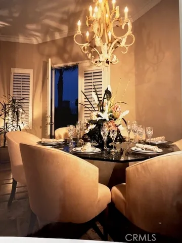 a view of a dining room with furniture and chandelier