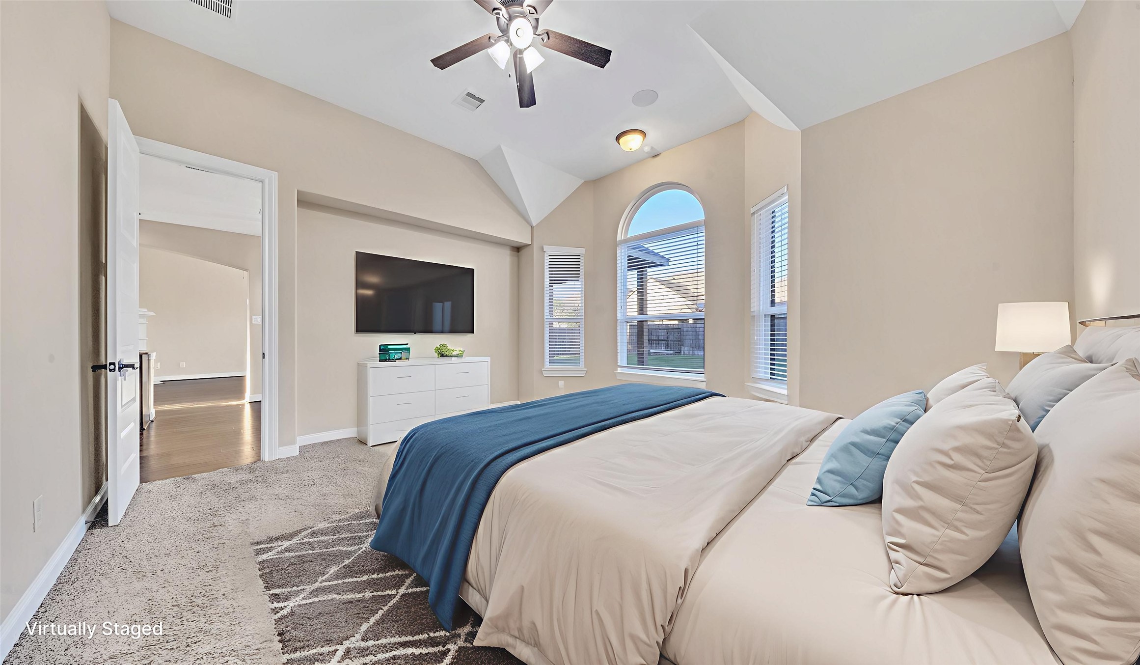 18118 Berry Garden Lane Spring, TX 77379 - Photo 17 of 45 a bedroom with a bed and a flat screen tv