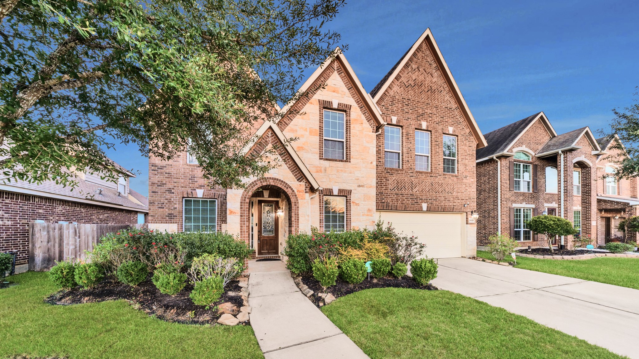 18118 Berry Garden Lane Spring, TX 77379 - Photo 2 of 45 a front view of a house with a yard and potted plants
