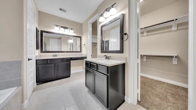 a bathroom with a double vanity sink and mirror