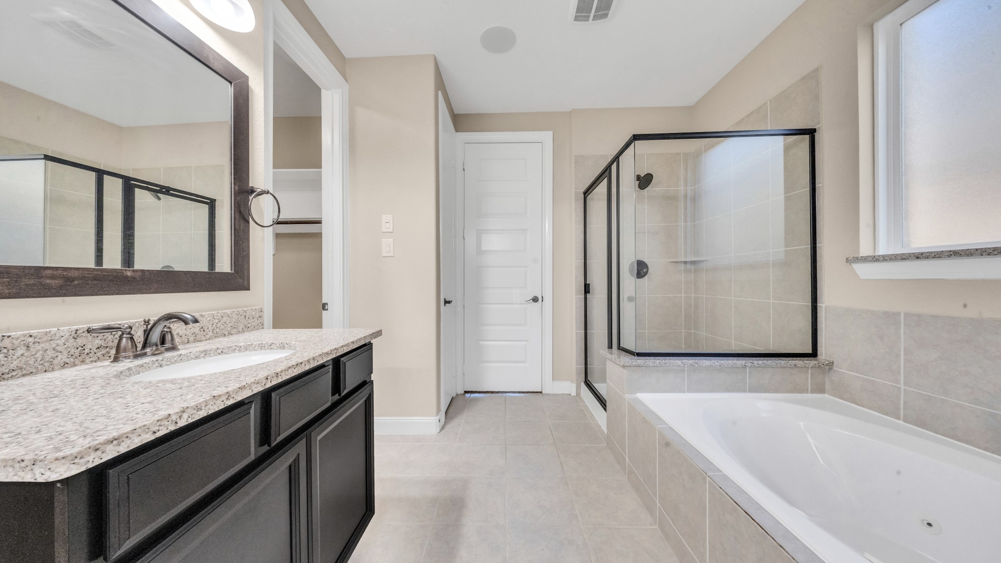18118 Berry Garden Lane Spring, TX 77379 - Photo 23 of 45 a spacious bathroom with a tub shower sink and mirror