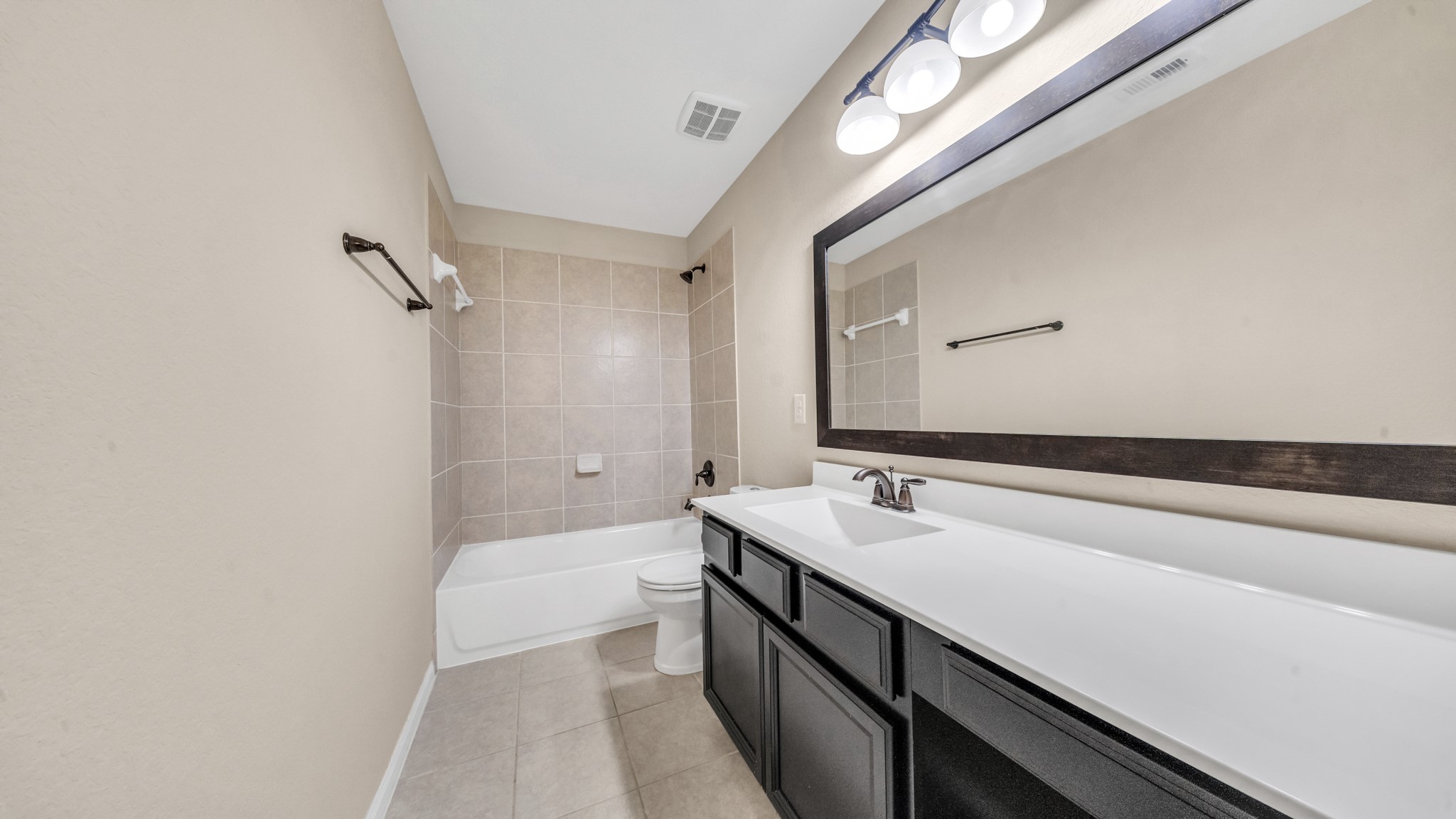 18118 Berry Garden Lane Spring, TX 77379 - Photo 36 of 45 a bathroom with a sink a large mirror and a bathtub