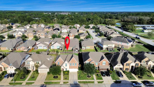 an aerial view of residential house with outdoor space and swimming pool