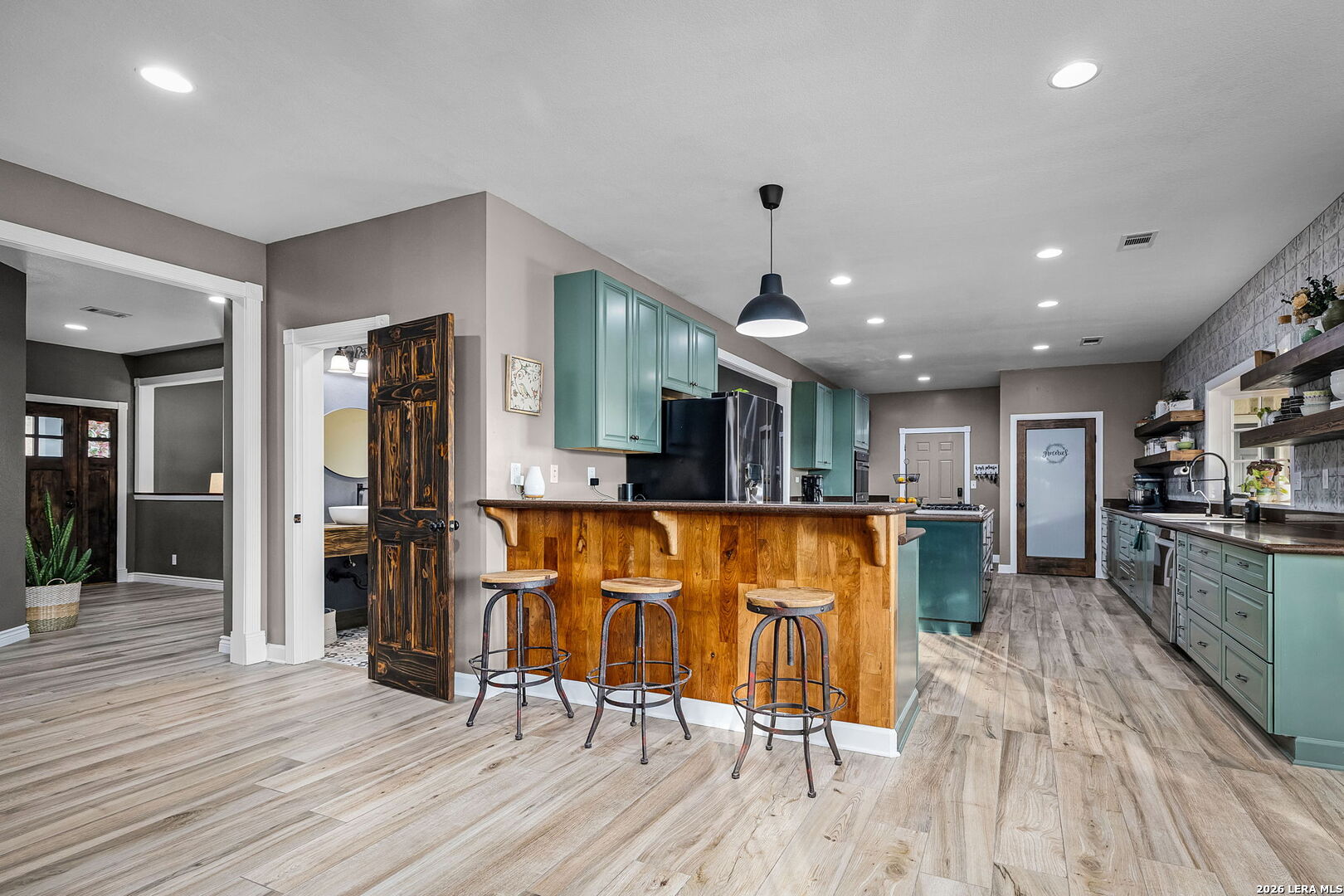 12700 Woman Hollering Road Schertz, TX 78154 - Photo 16 of 45 a view of kitchen with furniture and wooden floor