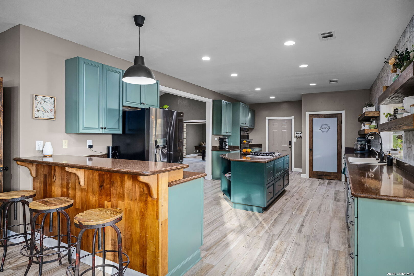 12700 Woman Hollering Road Schertz, TX 78154 - Photo 17 of 45 a large kitchen with a table and chairs in it