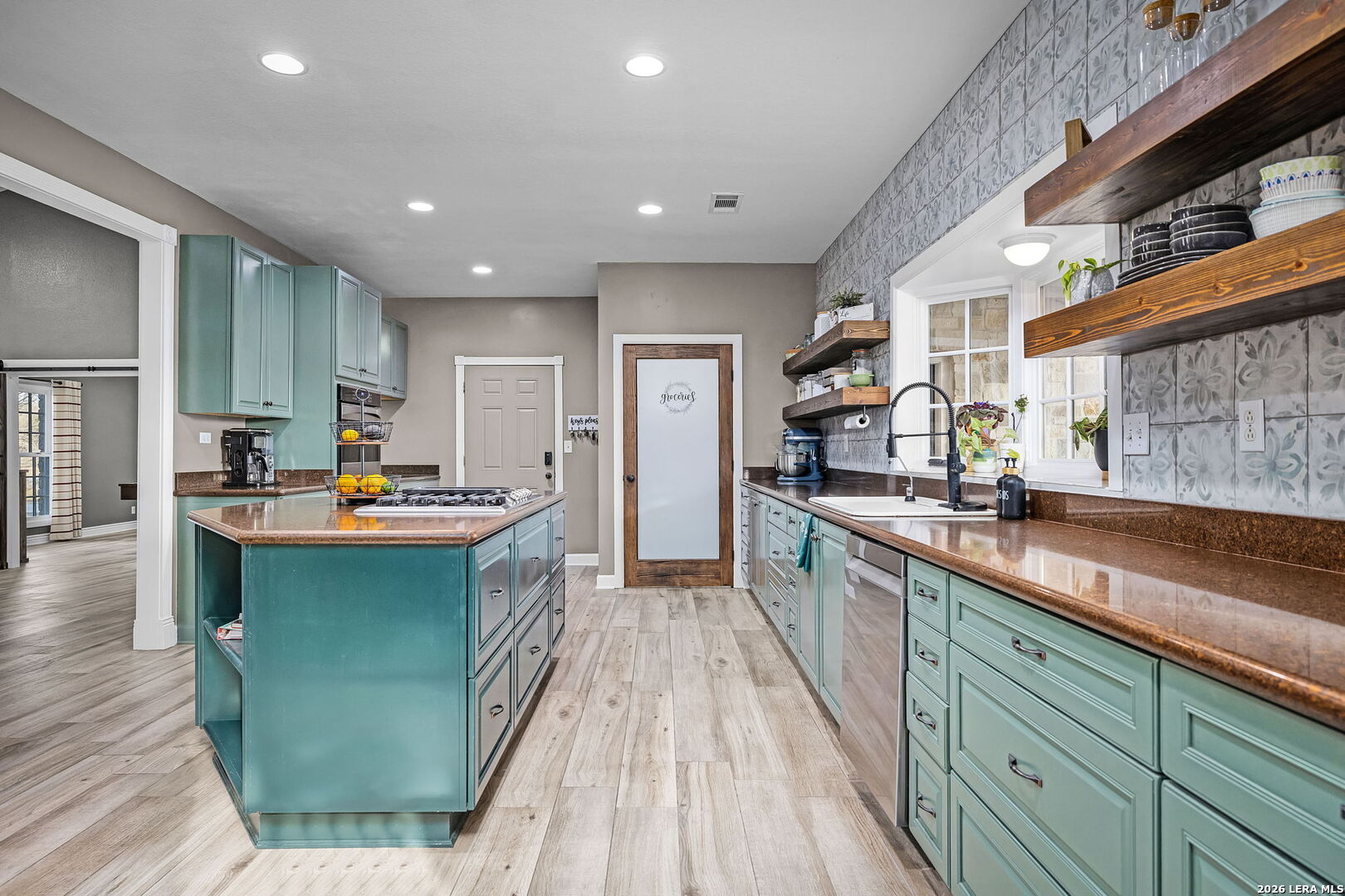 12700 Woman Hollering Road Schertz, TX 78154 - Photo 18 of 45 a large kitchen with kitchen island a sink dishwasher stove and wooden cabinets