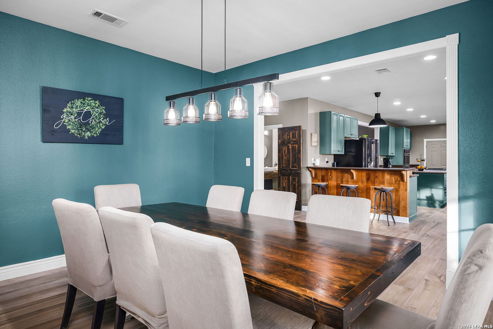 12700 Woman Hollering Road Schertz, TX 78154 - Photo 23 of 45 a living room with furniture kitchen view and a chandelier