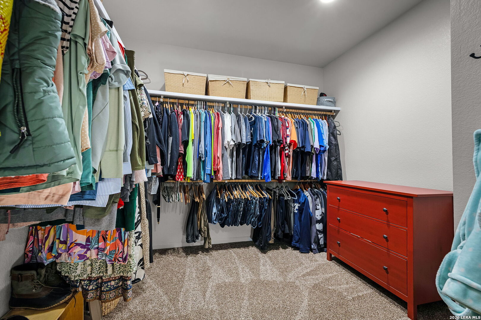 12700 Woman Hollering Road Schertz, TX 78154 - Photo 28 of 45 a view of walk in closet with clothes and shoes