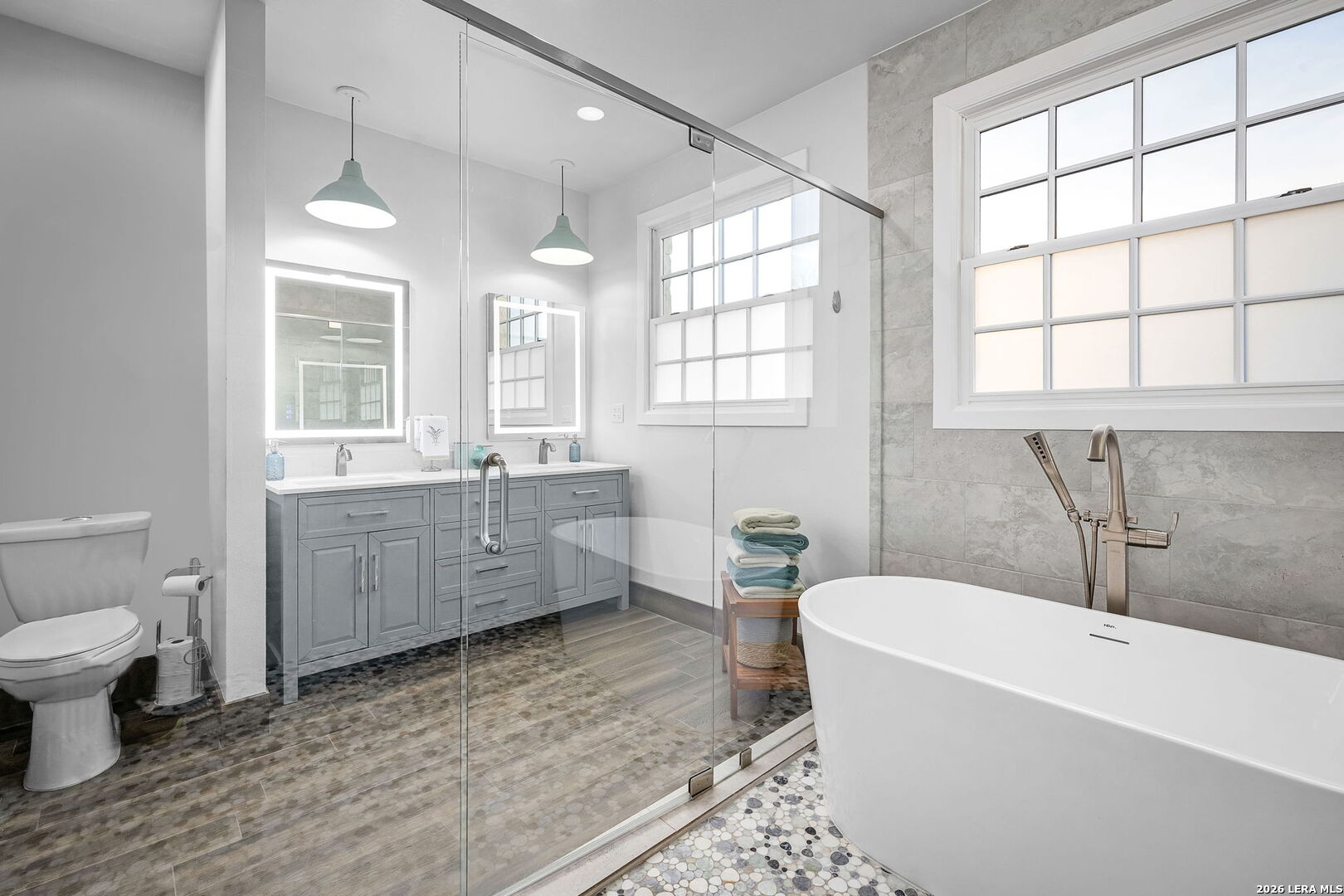 12700 Woman Hollering Road Schertz, TX 78154 - Photo 30 of 45 a bathroom with a granite countertop toilet a sink and bathtub