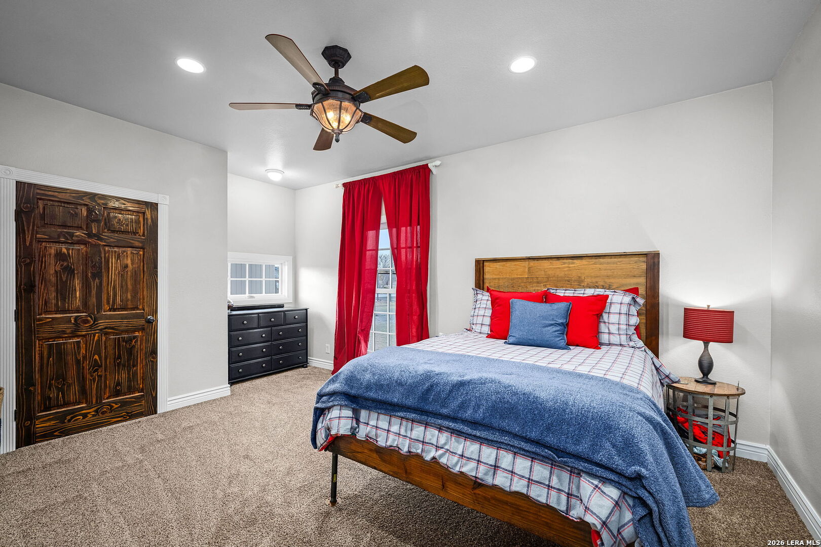 12700 Woman Hollering Road Schertz, TX 78154 - Photo 34 of 45 a bedroom with a bed and a chandelier