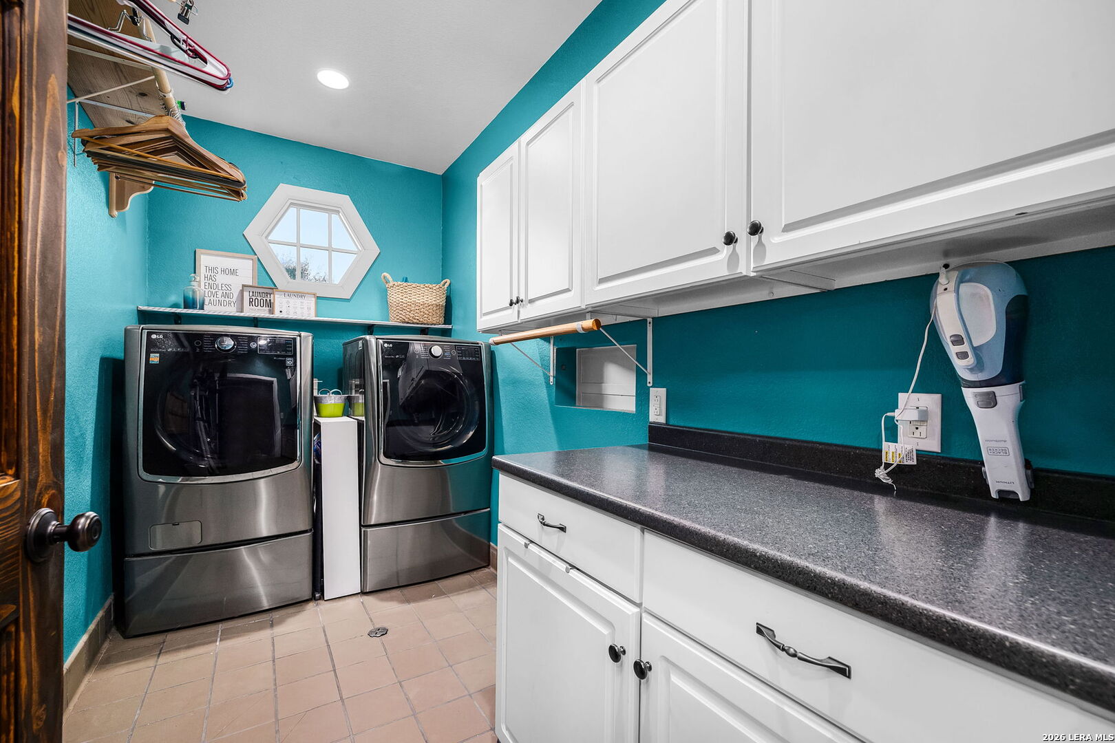 12700 Woman Hollering Road Schertz, TX 78154 - Photo 35 of 45 a kitchen with stainless steel appliances granite countertop a sink a stove and a refrigerator