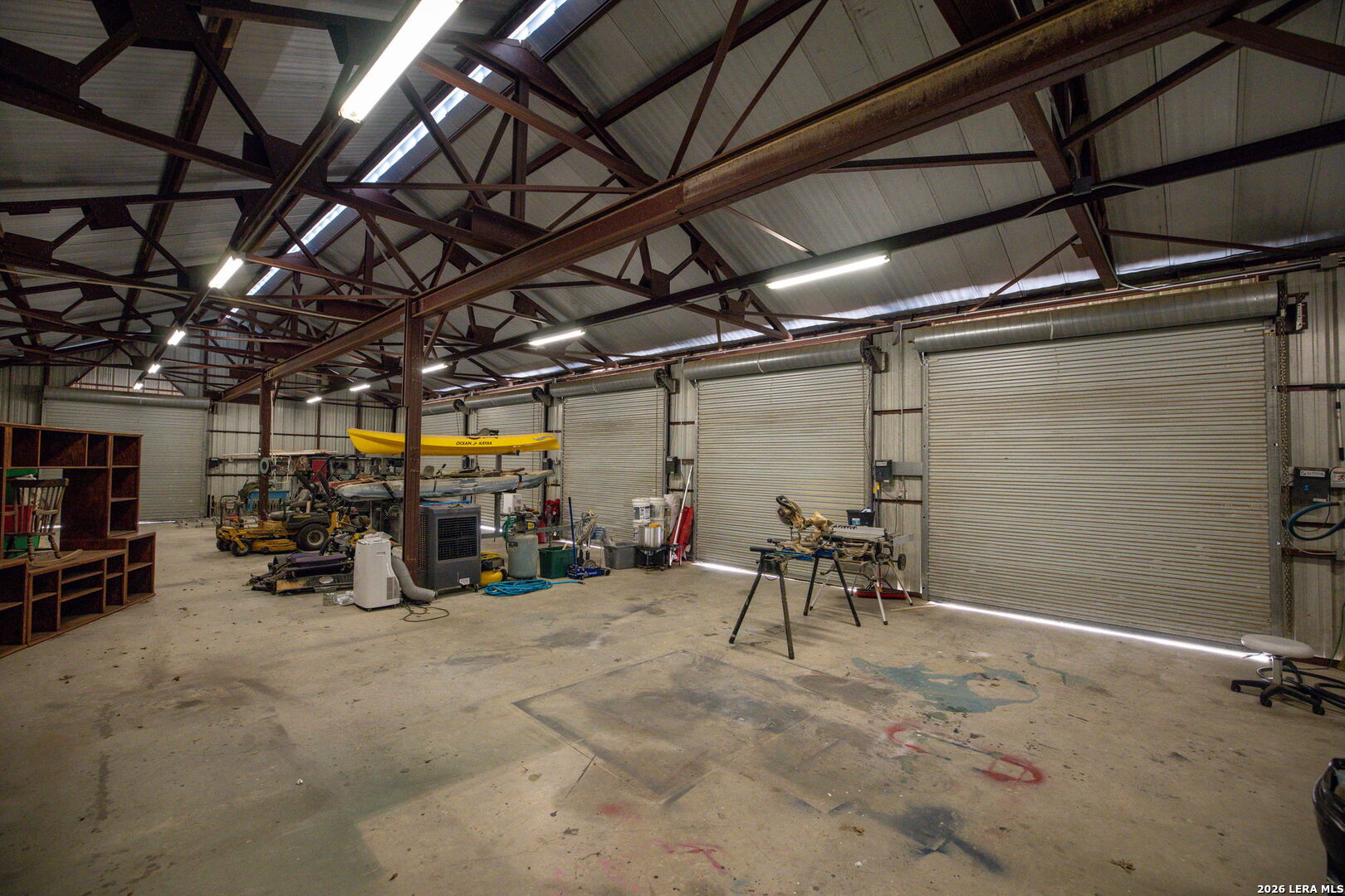 12700 Woman Hollering Road Schertz, TX 78154 - Photo 40 of 45 a view of a garage with a table and chairs
