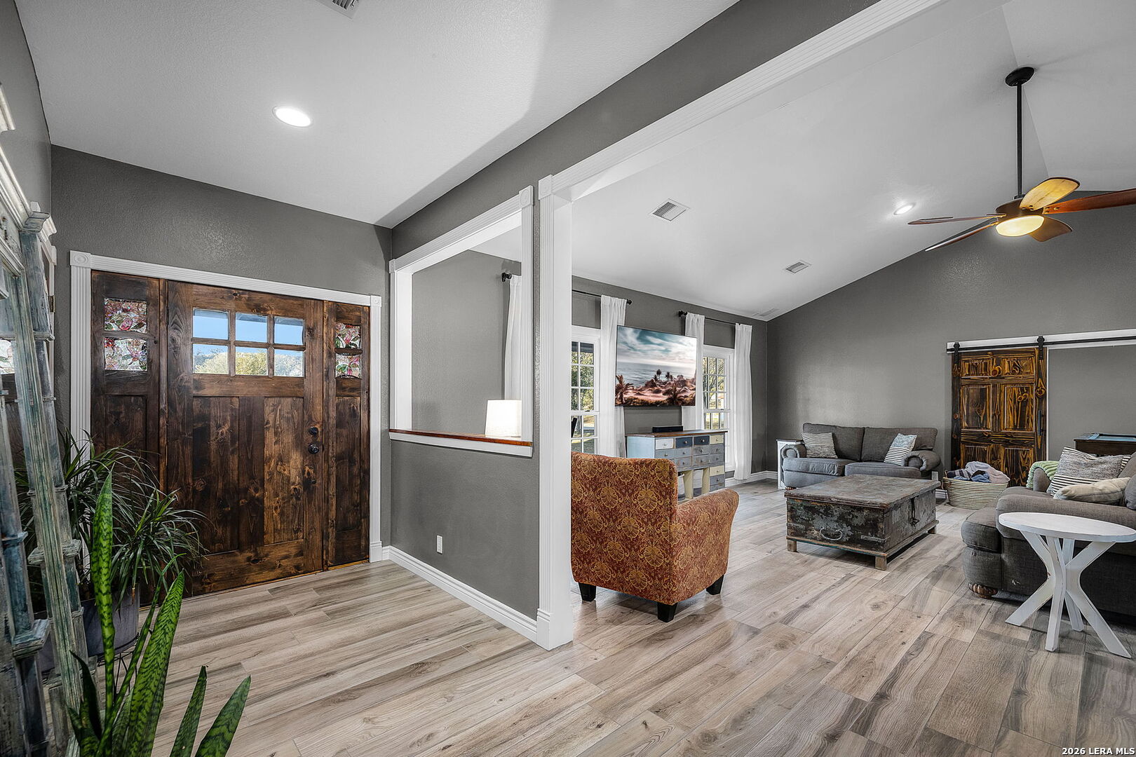 12700 Woman Hollering Road Schertz, TX 78154 - Photo 8 of 45 a living room with furniture a wooden floor and next to a window