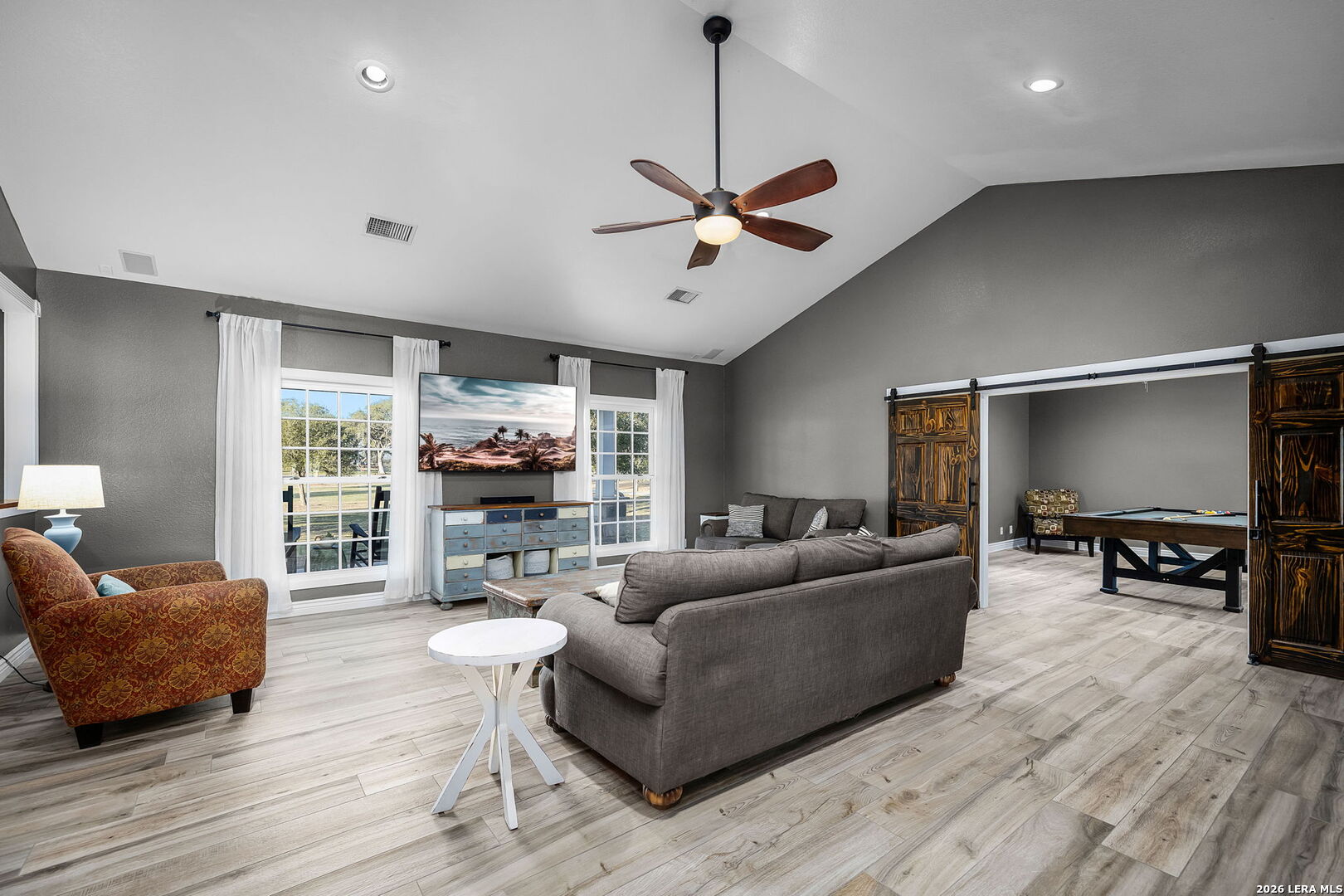12700 Woman Hollering Road Schertz, TX 78154 - Photo 9 of 45 a living room with furniture and a flat screen tv