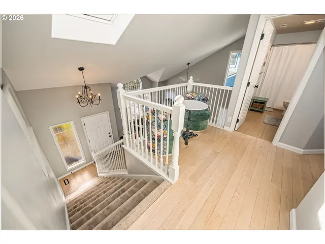 a view of wooden floor in a hall with a window