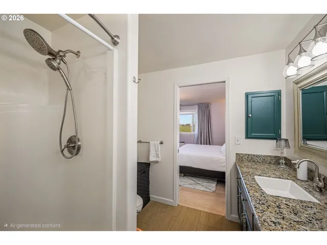 a en suite bathroom with a granite countertop sink and a mirror