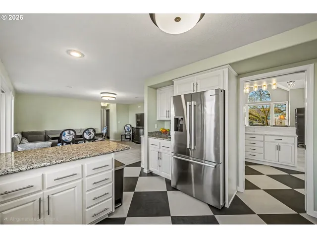 a kitchen with a refrigerator and a sink