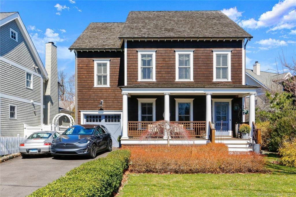 a front view of a house with yard porch and furniture