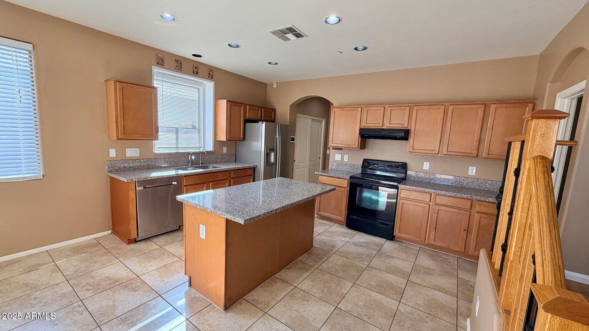 21549 Backus Drive Maricopa, AZ 85138 - Photo 10 of 28 a kitchen with stainless steel appliances granite countertop a stove a sink and a refrigerator