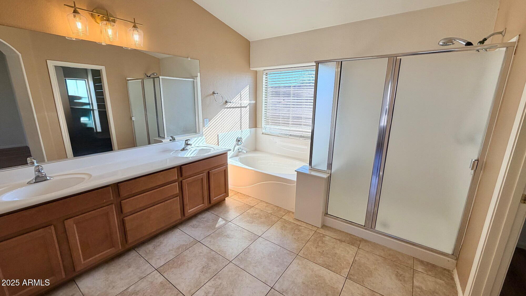 21549 Backus Drive Maricopa, AZ 85138 - Photo 23 of 28 a spacious bathroom with a double vanity sink a mirror and a shower