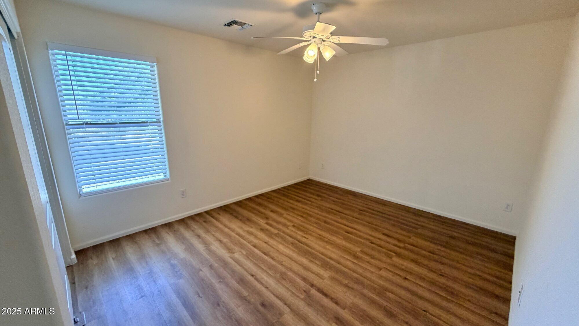 21549 Backus Drive Maricopa, AZ 85138 - Photo 26 of 28 wooden floor in an empty room with a window