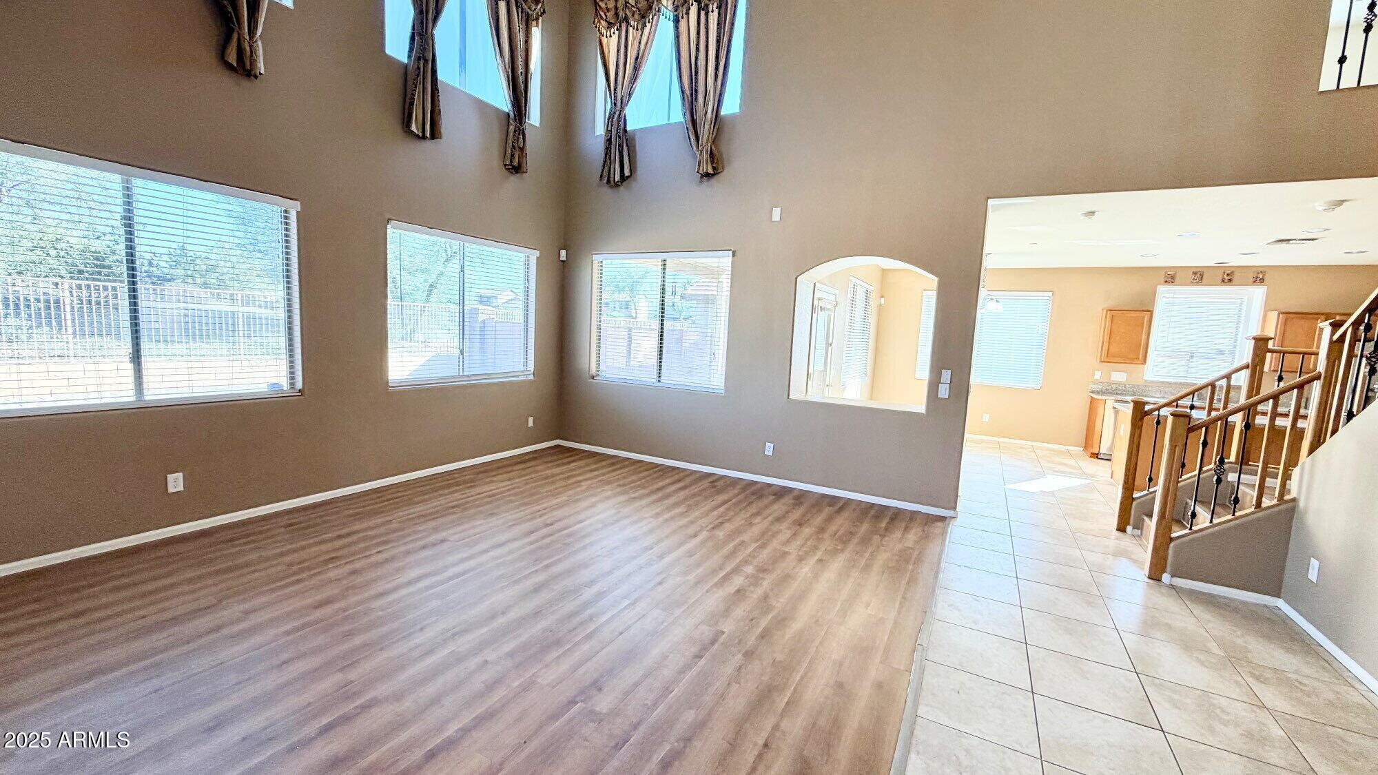21549 Backus Drive Maricopa, AZ 85138 - Photo 9 of 28 a view of an empty room with window and wooden floor