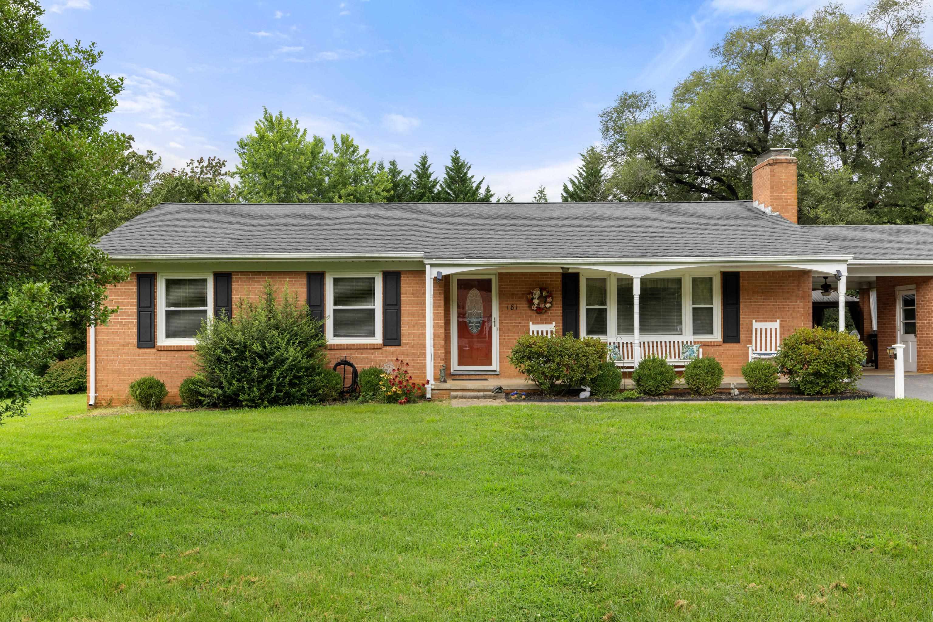181 Ridge Street Lovingston, VA 22949 - Photo 1 of 56 a front view of a house with a garden
