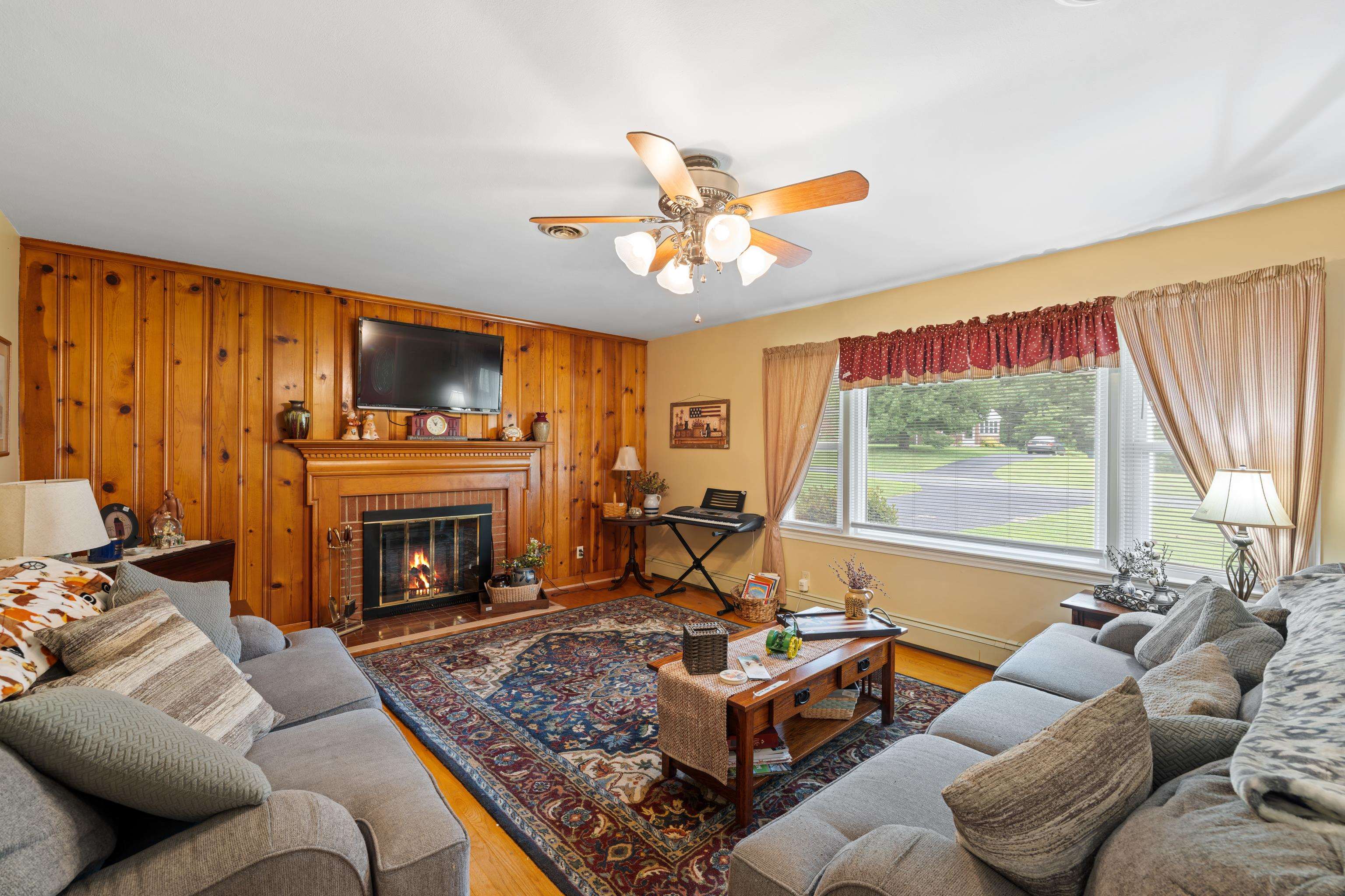 181 Ridge Street Lovingston, VA 22949 - Photo 12 of 56 a living room with furniture a fireplace and a large window