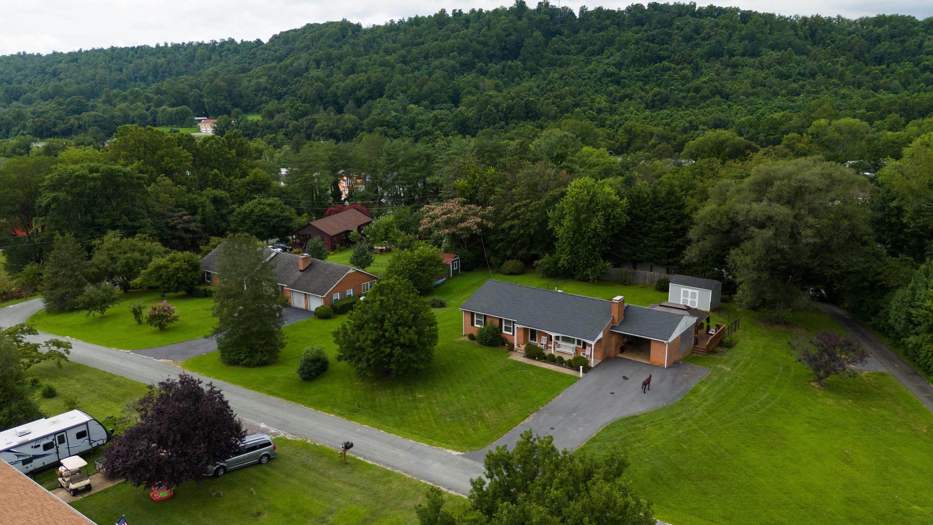 181 Ridge Street Lovingston, VA 22949 - Photo 51 of 56 an aerial view of a house with pool yard outdoor and green space