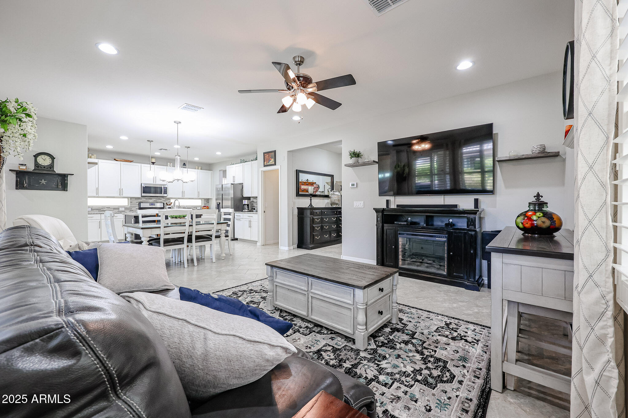 17563 West Fairview Street Goodyear, AZ 85338 - Photo 11 of 66 a living room with furniture and a flat screen tv