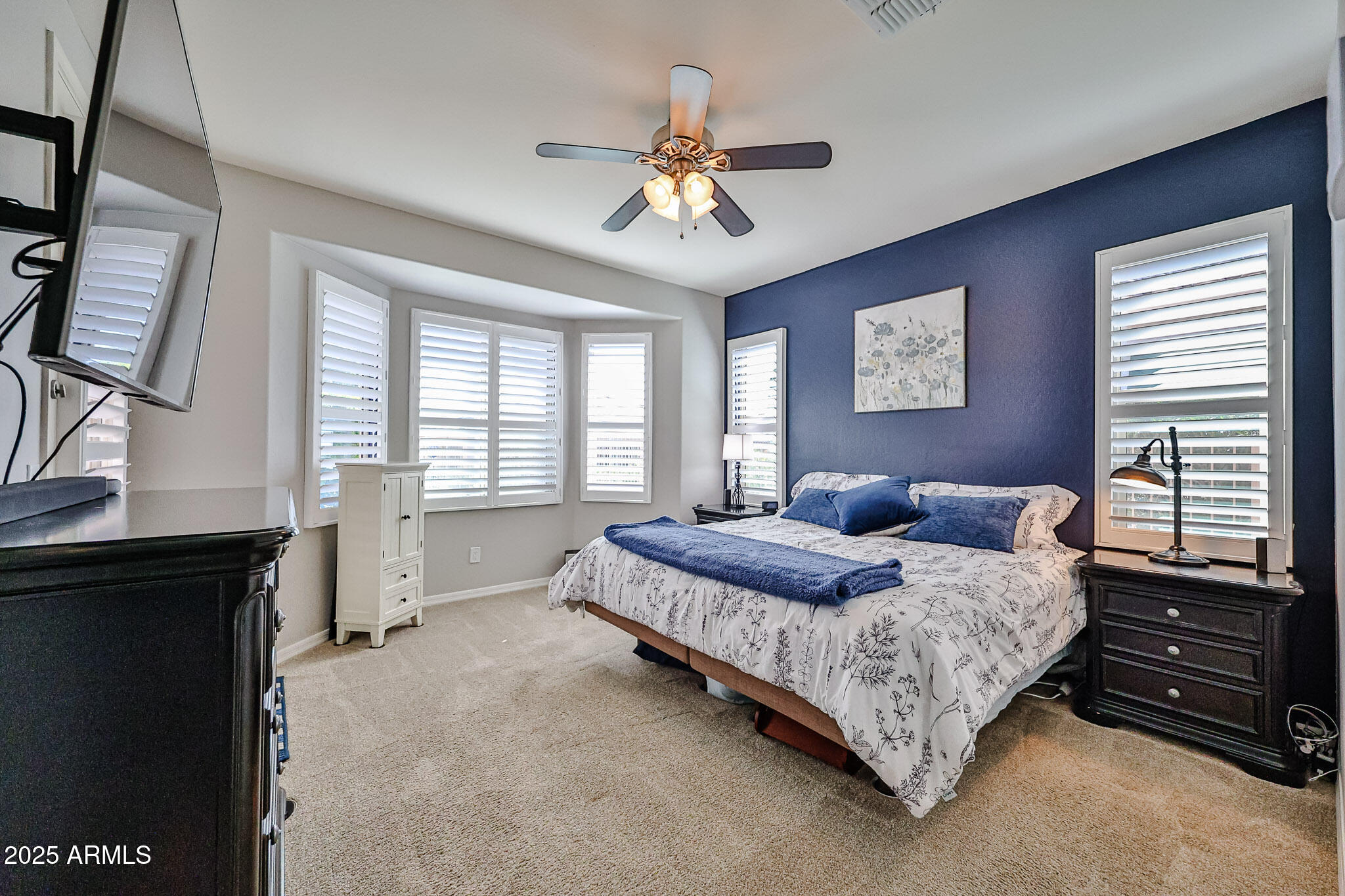 17563 West Fairview Street Goodyear, AZ 85338 - Photo 22 of 66 a bedroom with a bed and a chandelier