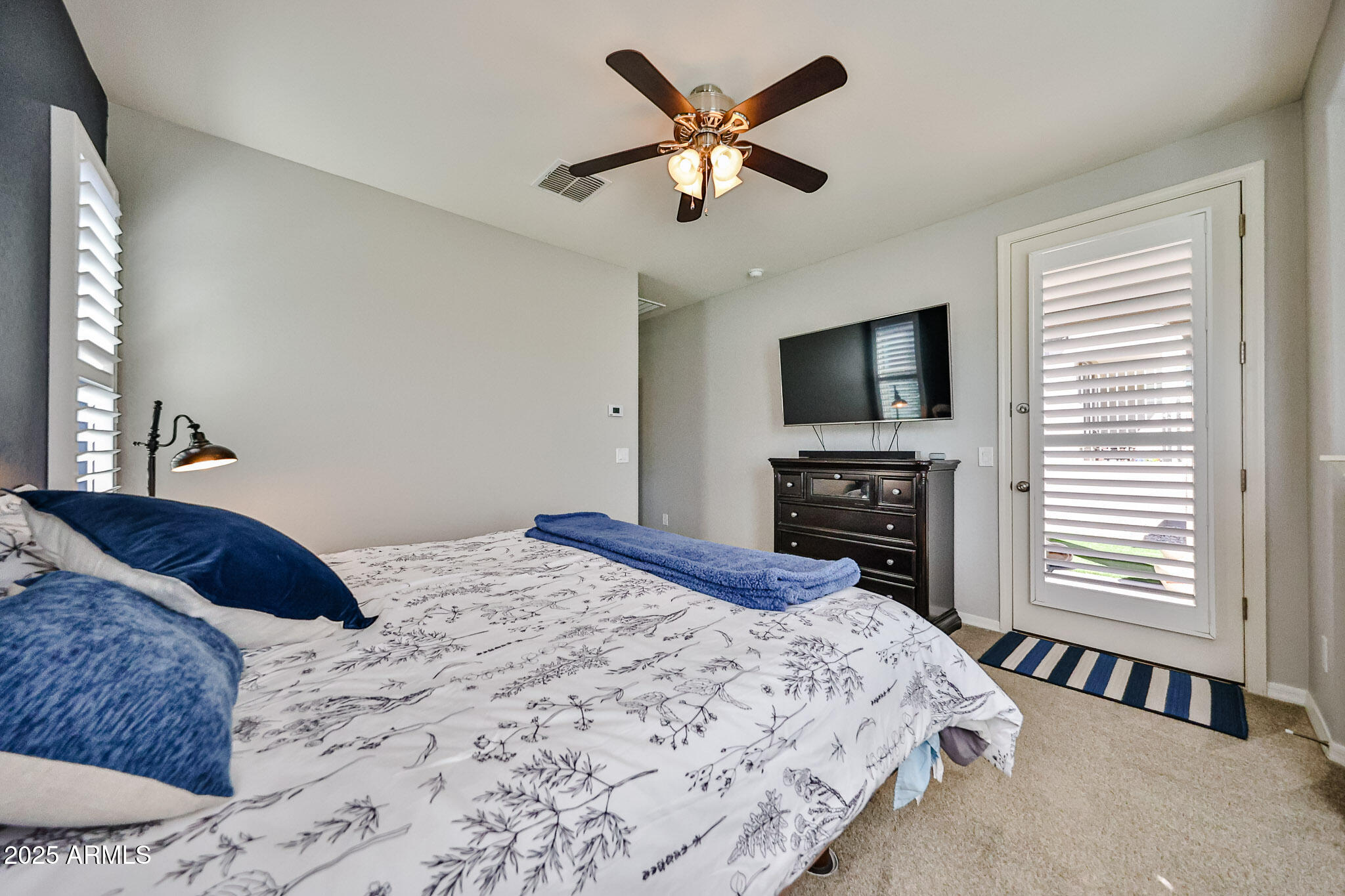 17563 West Fairview Street Goodyear, AZ 85338 - Photo 24 of 66 a bedroom with a bed and a flat screen tv