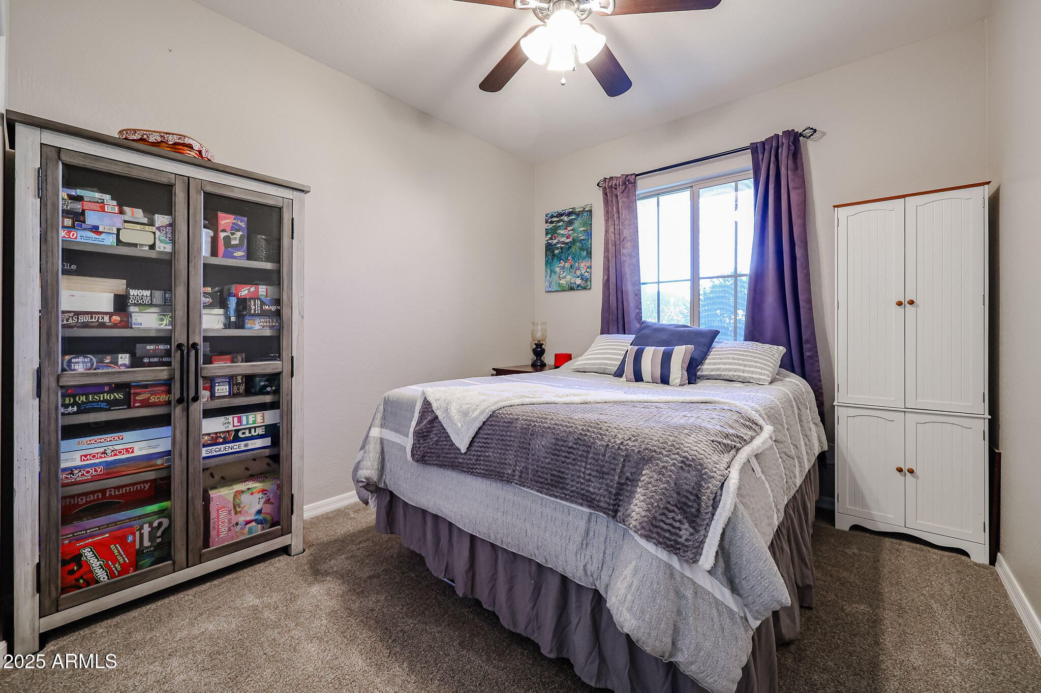 17563 West Fairview Street Goodyear, AZ 85338 - Photo 29 of 66 a bedroom with a bed and a book shelf