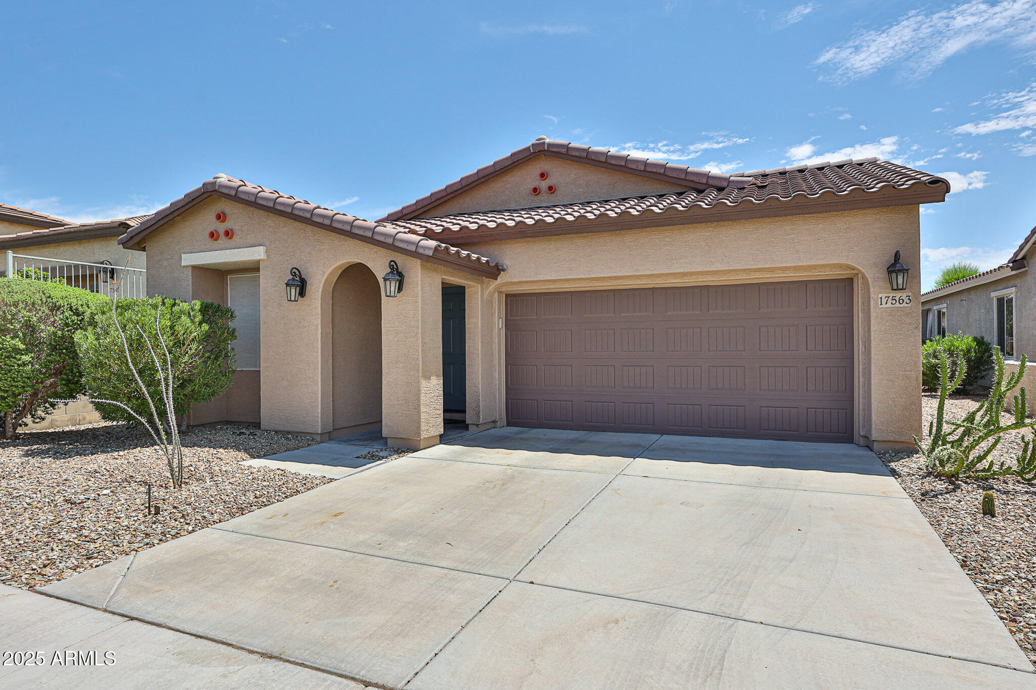 17563 West Fairview Street Goodyear, AZ 85338 - Photo 3 of 66 a front view of a house with garden