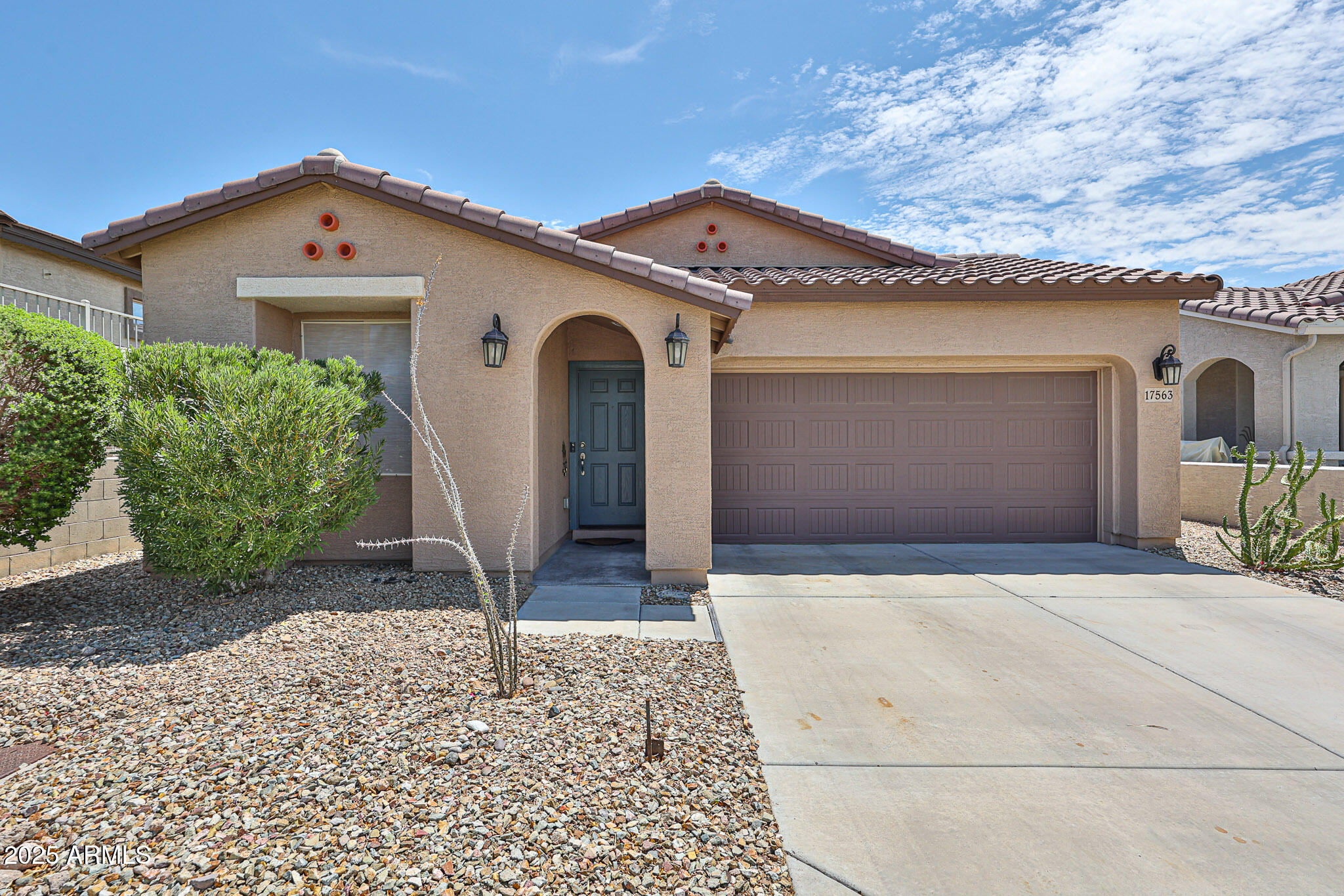17563 West Fairview Street Goodyear, AZ 85338 - Photo 4 of 66 a front view of a house with a yard