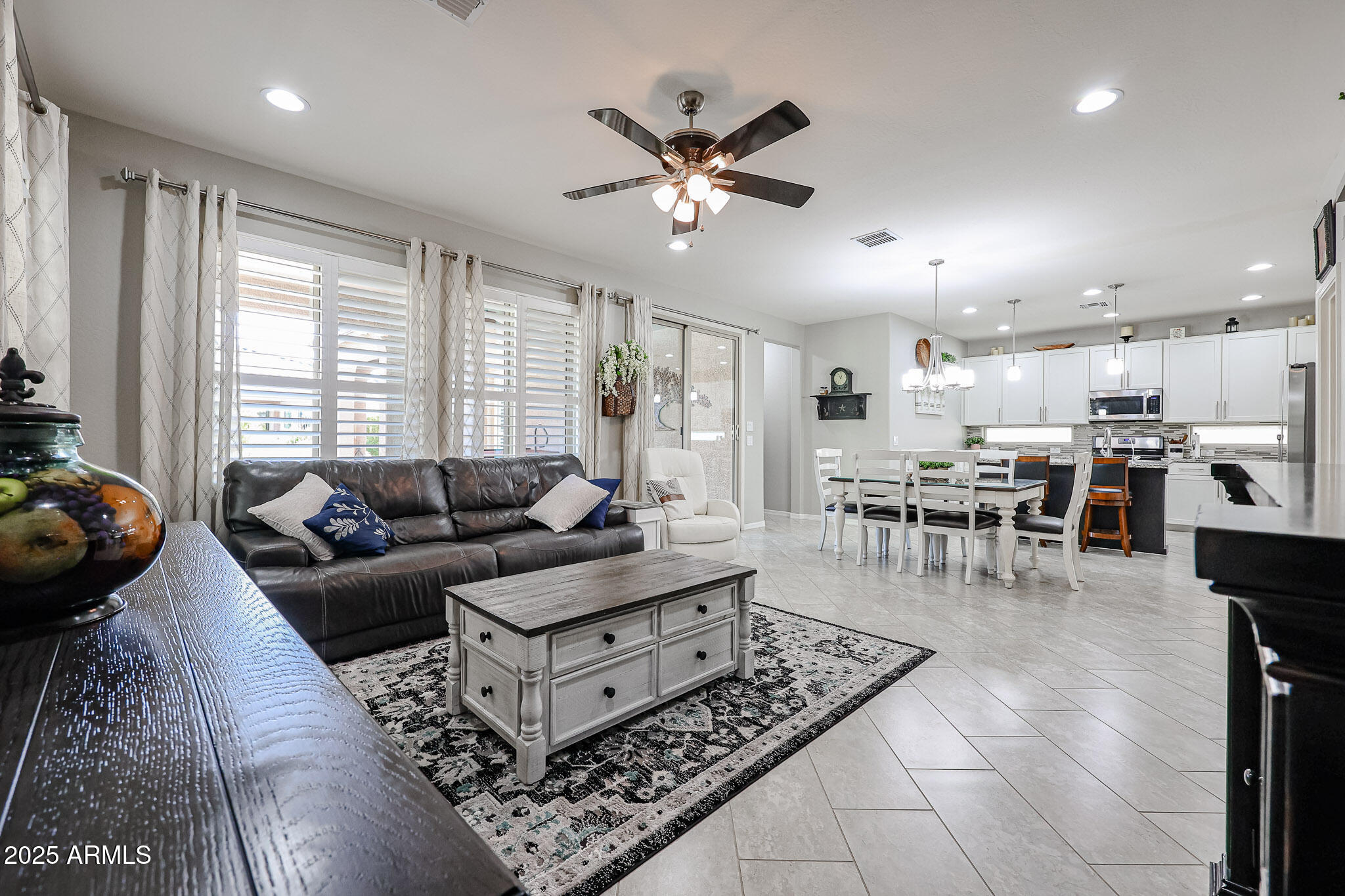 17563 West Fairview Street Goodyear, AZ 85338 - Photo 9 of 66 a living room with furniture and kitchen view with wooden floor