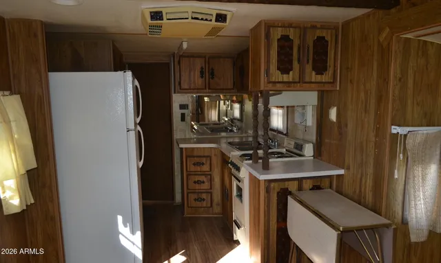 a kitchen with stainless steel appliances a refrigerator and a stove