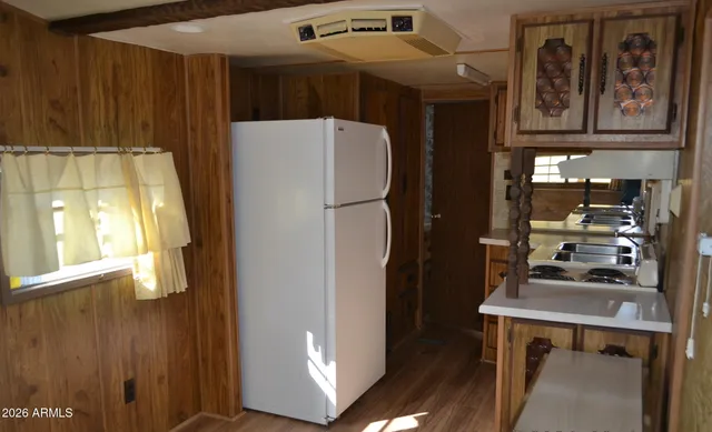 a refrigerator freezer sitting inside of a kitchen