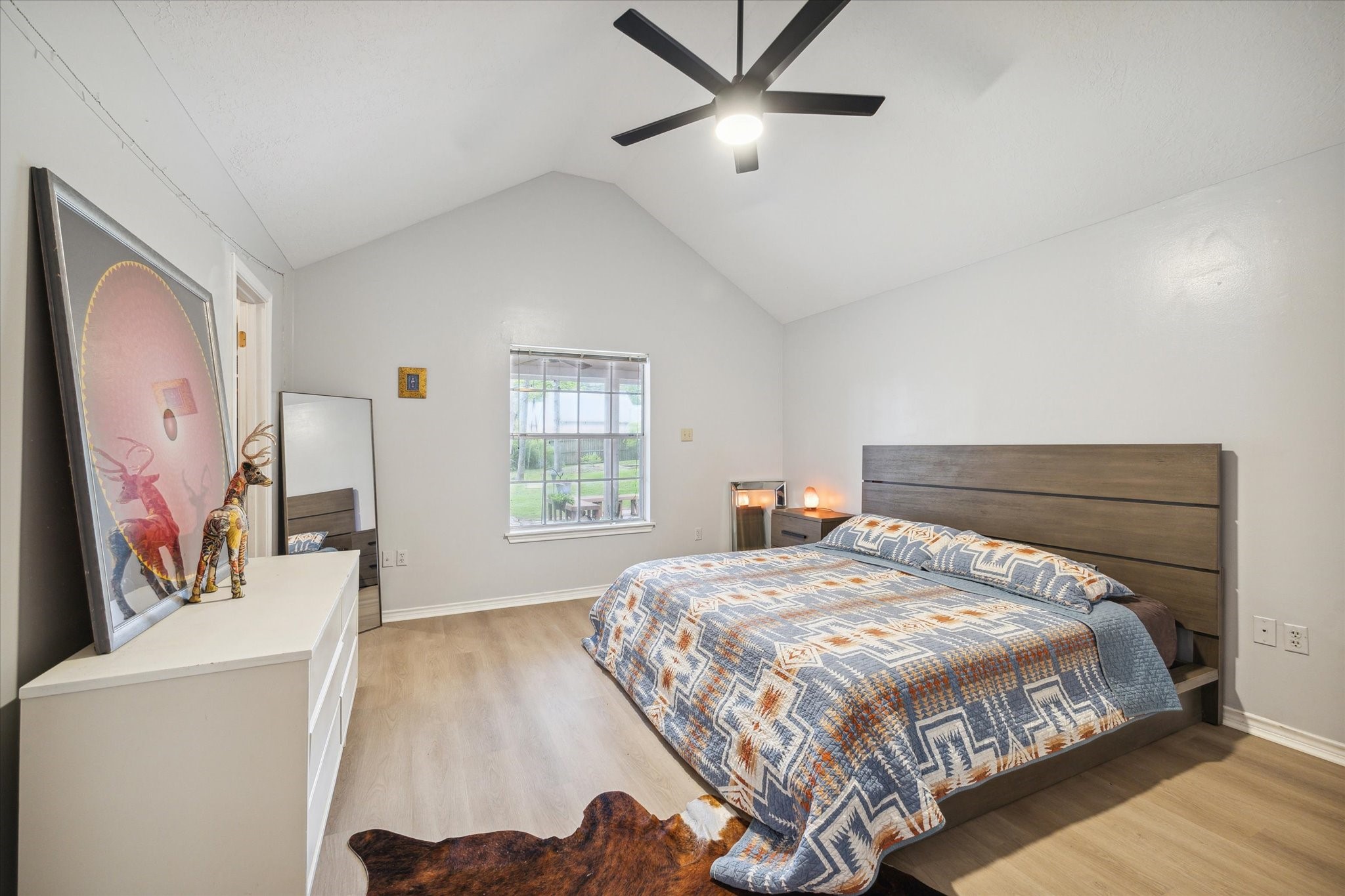 2420 Canter Lane Conroe, TX 77384 - Photo 15 of 24 a bedroom with a large bed and a chandelier