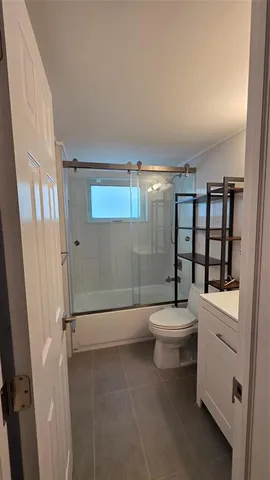 a bathroom with a toilet a sink and shower