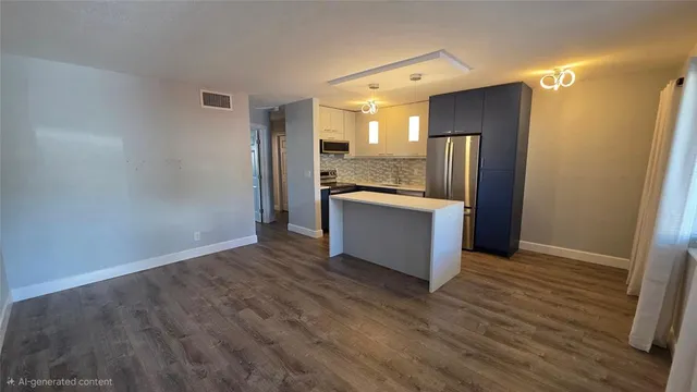 a view of a kitchen with wooden floor and electronic appliances