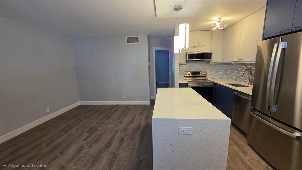 2607 Northeast 8th Avenue, Unit 14 Wilton Manors, FL 33334 - Photo 6 of 12 a kitchen with a refrigerator sink and wooden floor